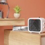 Termoventilatore ceramico Nevala 2in1 bianco compatto con ventilatore su un tavolo.