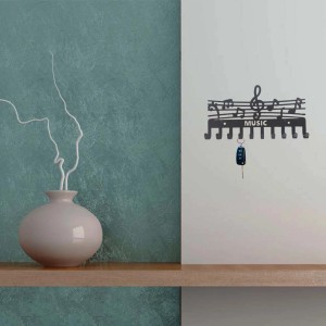 Portachiavi nero "Music" con note musicali come decorazione da parete.