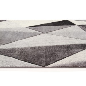 Tappeto moderno con motivo geometrico a triangoli in tonalità di grigio e bianco.