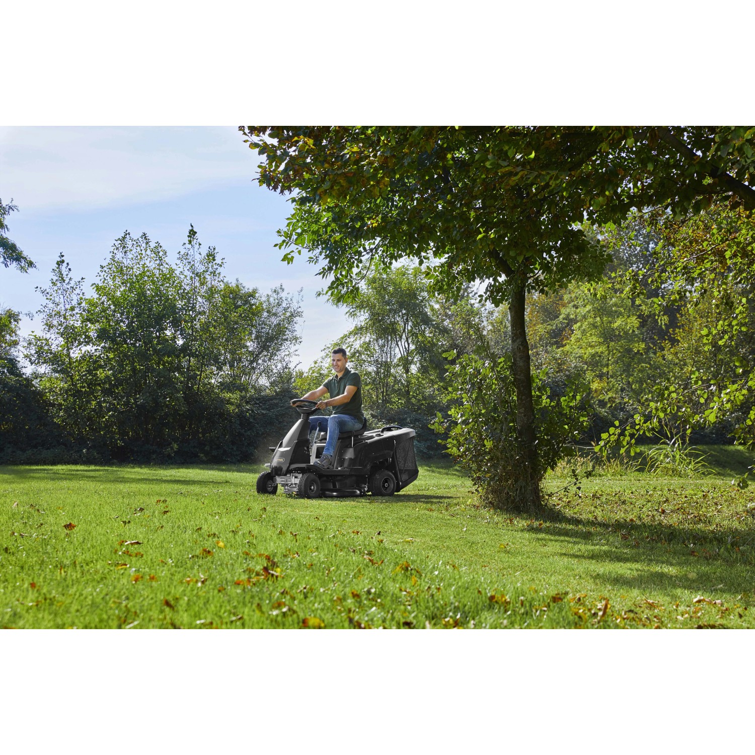 Trattorino tagliaerba Alpina AT2 66 QA mentre taglia l'erba in un prato verde.