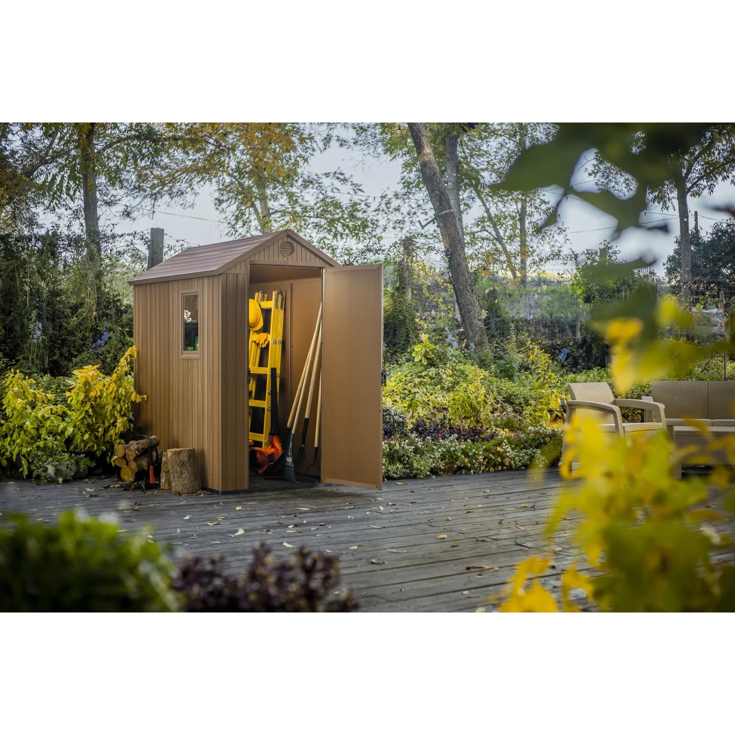Casetta da giardino in plastica t.b.t. marrone aperta con scala e attrezzi da giardino.