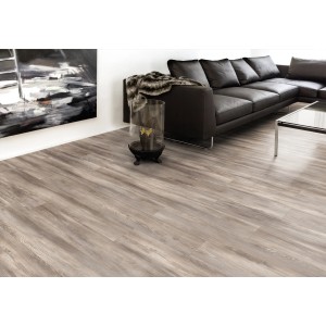 Pavimento laminato Comfort Kiefer Genua 7 mm posato in soggiorno con divano e decorazioni.