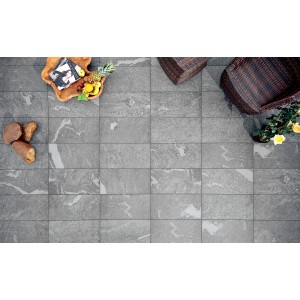 Piastrelle per esterni grigie marmorizzate, abbinate a mobili da giardino e decorazioni.