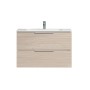 Mobile bagno in legno chiaro con due cassetti e rubinetto.
