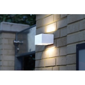 Lampada da parete per esterni a LED LUTEC Gemini bianca su muro di mattoni, che emette luce verso l'alto e verso il basso.