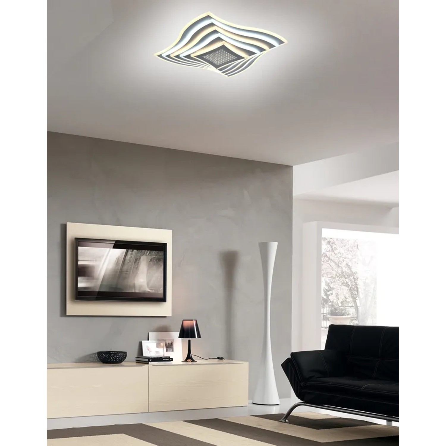 Plafoniera LED t.b.t. moderna con design curvo per spazi abitativi.