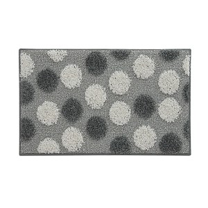 Tappeto da bagno grigio con pois bianchi e scuri.