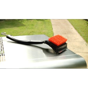 Spazzola per griglia Char-Broil Cool Clean Premium con setole e raschietto su una griglia.