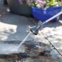 Lancia per irrigazione t.b.t. in azione, getto d'acqua su pavimento in pietra.