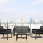 Set di mobili da giardino t.b.t. nero con divano, due sedie e tavolo su una terrazza.