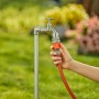 Tubo da giardino collegato a un rubinetto con un raccordo per irrigazione t.b.t.