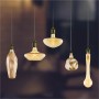 Diverse forme di lampadine LED E27, color oro, sospese.