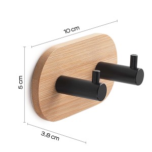 Appendiabiti da parete con due ganci neri su pannello ovale in bambù, parte di Accessori da parete e contenitori.