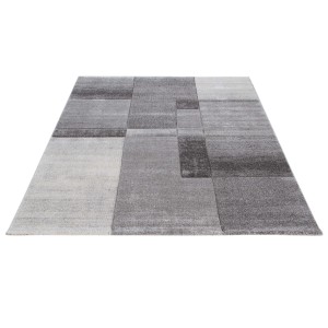 Tappeto moderno con motivo geometrico nei toni del grigio e del bianco.