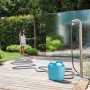 Sistema di irrigazione t.b.t. con tubo e cesto di stoccaggio in giardino.
