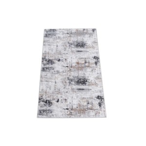 Tappeto moderno con motivo astratto nei toni del grigio, nero e beige.