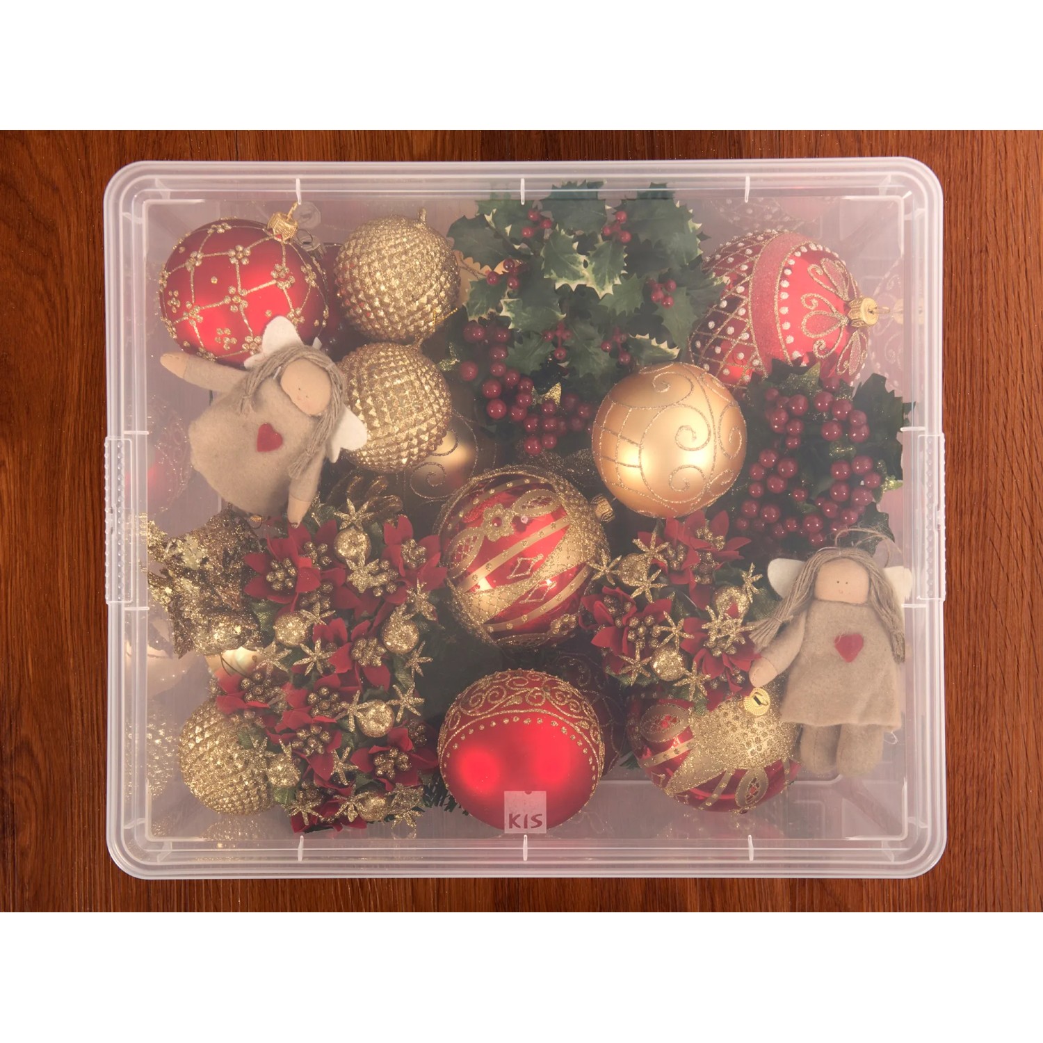 Scatola contenitore trasparente C M con coperchio, piena di decorazioni natalizie.