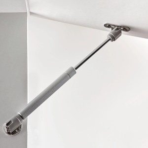 Supporto per anta Hettich Lift Basic in acciaio e plastica, montato su un frontale mobile bianco.