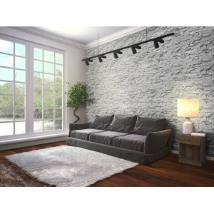 Soggiorno con rivestimento murale t.b.t. grigio effetto pietra.