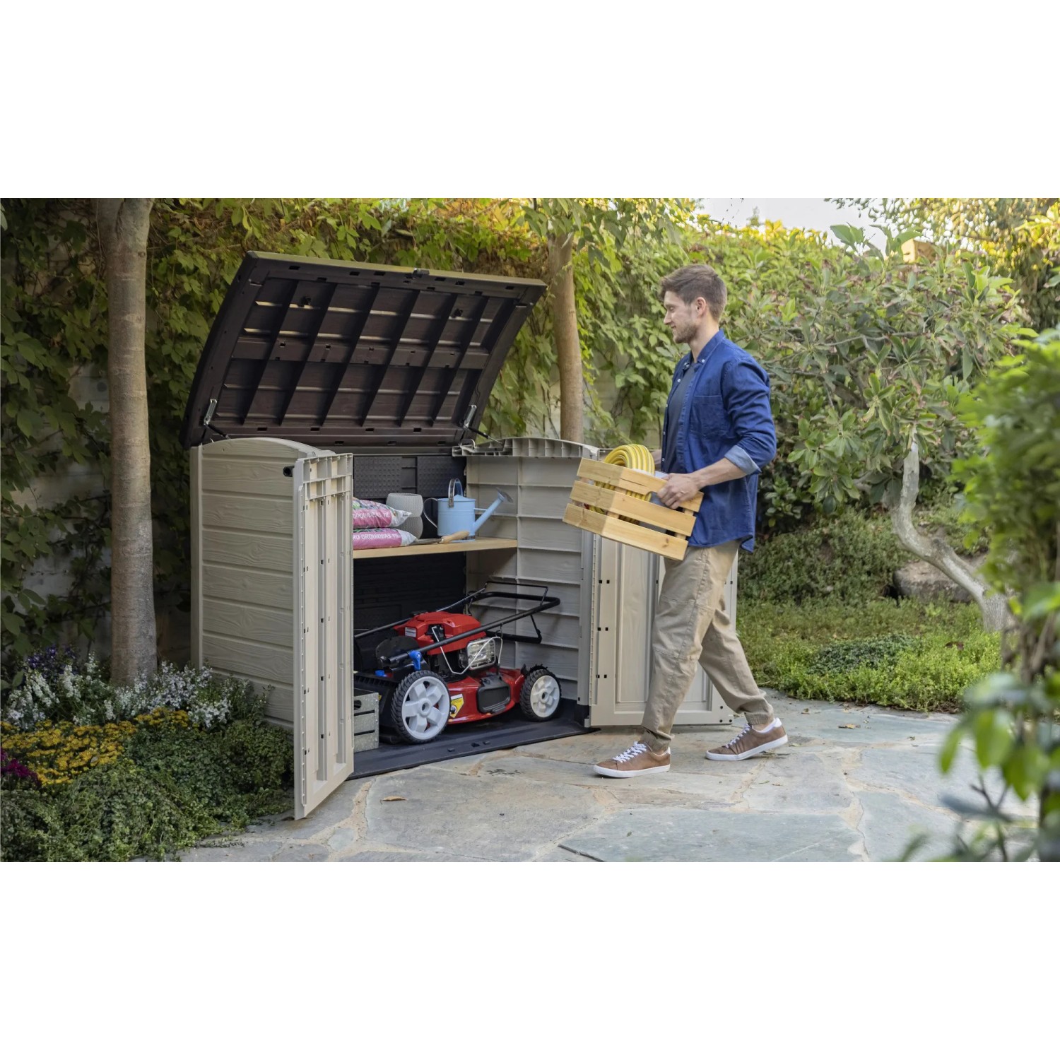 Box universale aperta beige-marrone con tosaerba e uomo con cassa in giardino.