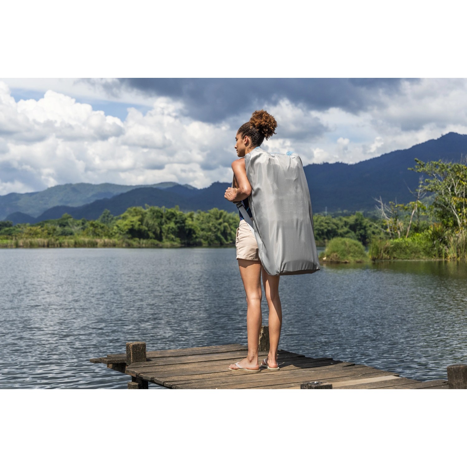 Donna con Bestway SUP Board-Set Oceana nello zaino al lago.