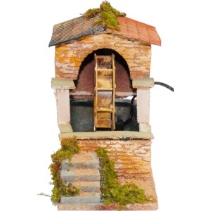 Dettaglio di una scena del presepe con un mulino ad acqua in miniatura.