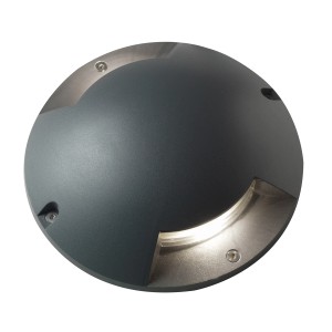 Faretto da incasso a terra rotondo per esterni, corpo grigio con emissione di luce.