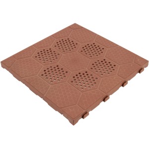 Piastrella autobloccante t.b.t. marrone con motivo esagonale e fori per esterni.