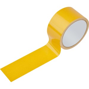 Nastro biadesivo giallo per pavimenti, 50 mm x 10 m, rotolo parzialmente srotolato. Per tappeti e fissaggi interni.