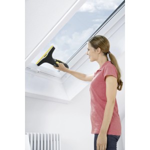 Donna pulisce finestra con Kärcher WV 2 Premium 10 Years Edition.