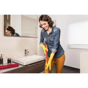 Donna pulisce il bagno con guanti Vileda Der Griffige Universal Grip M gialli.