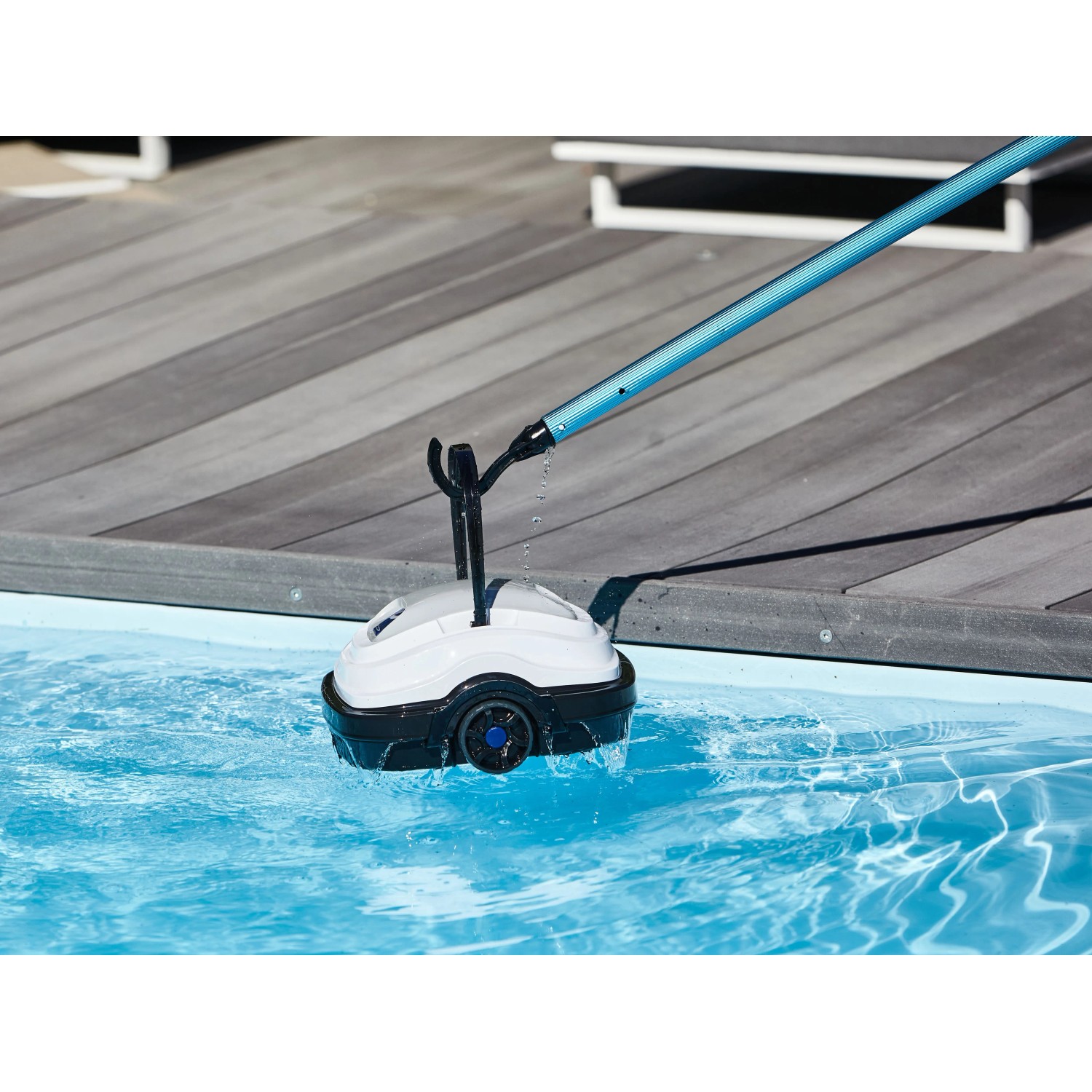 Robot piscina a batteria Orca 45 CL in piscina, bianco/nero, con asta. Pulisce piscine fino a 50 m².