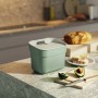 Cestino t.b.t. verde menta su un bancone da cucina con avocado e pane.