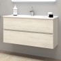 Mobile bagno sospeso in legno chiaro con due cassetti e lavabo da appoggio.