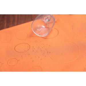 Tovaglia arancione con motivo a cerchi e gocce d'acqua, adatta per il negozio online OBI.