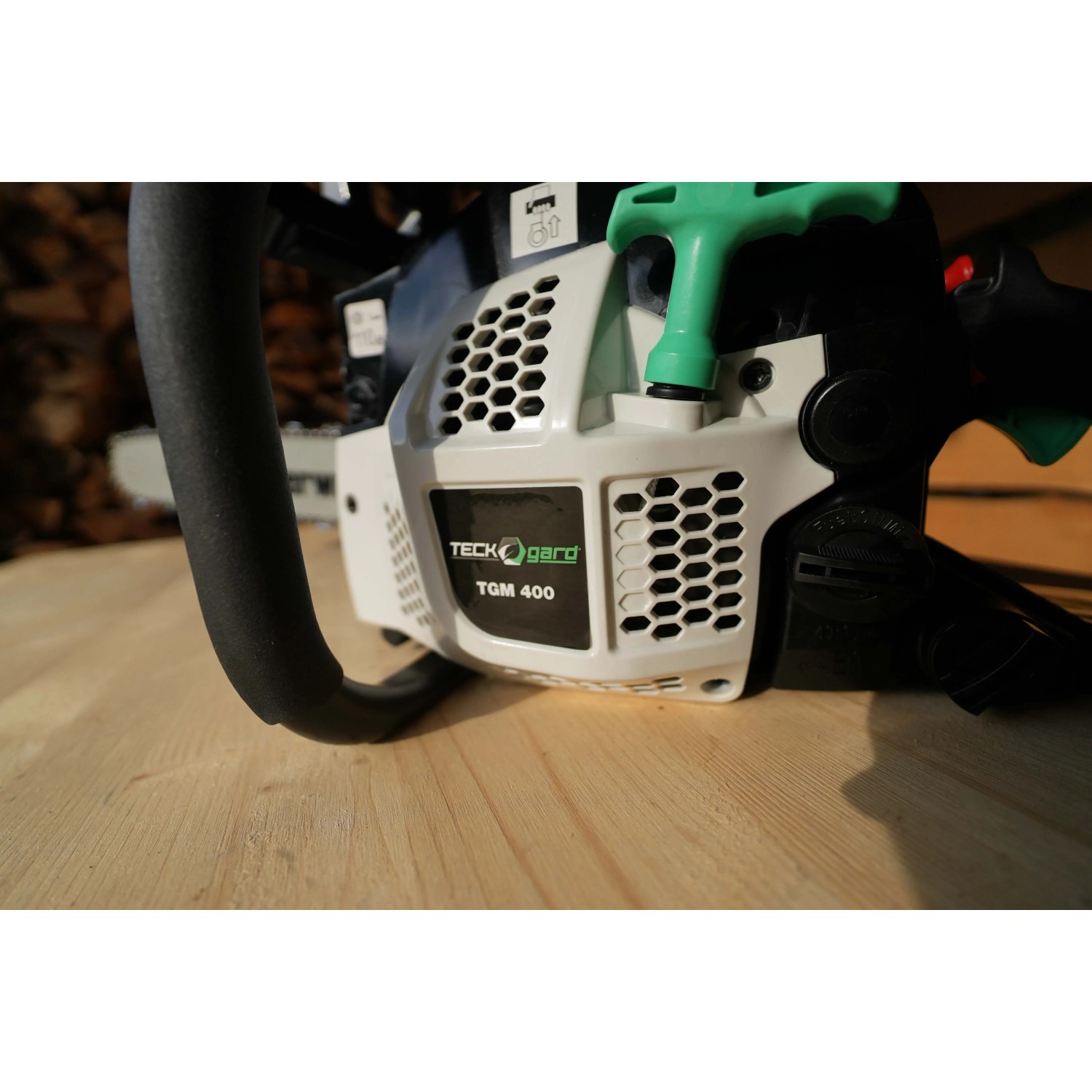 Primo piano di una motosega Teckgard TGM 400 con manico nero e avviamento verde.