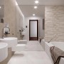Bagno con piastrelle da rivestimento t.b.t. beige e sanitari bianchi.