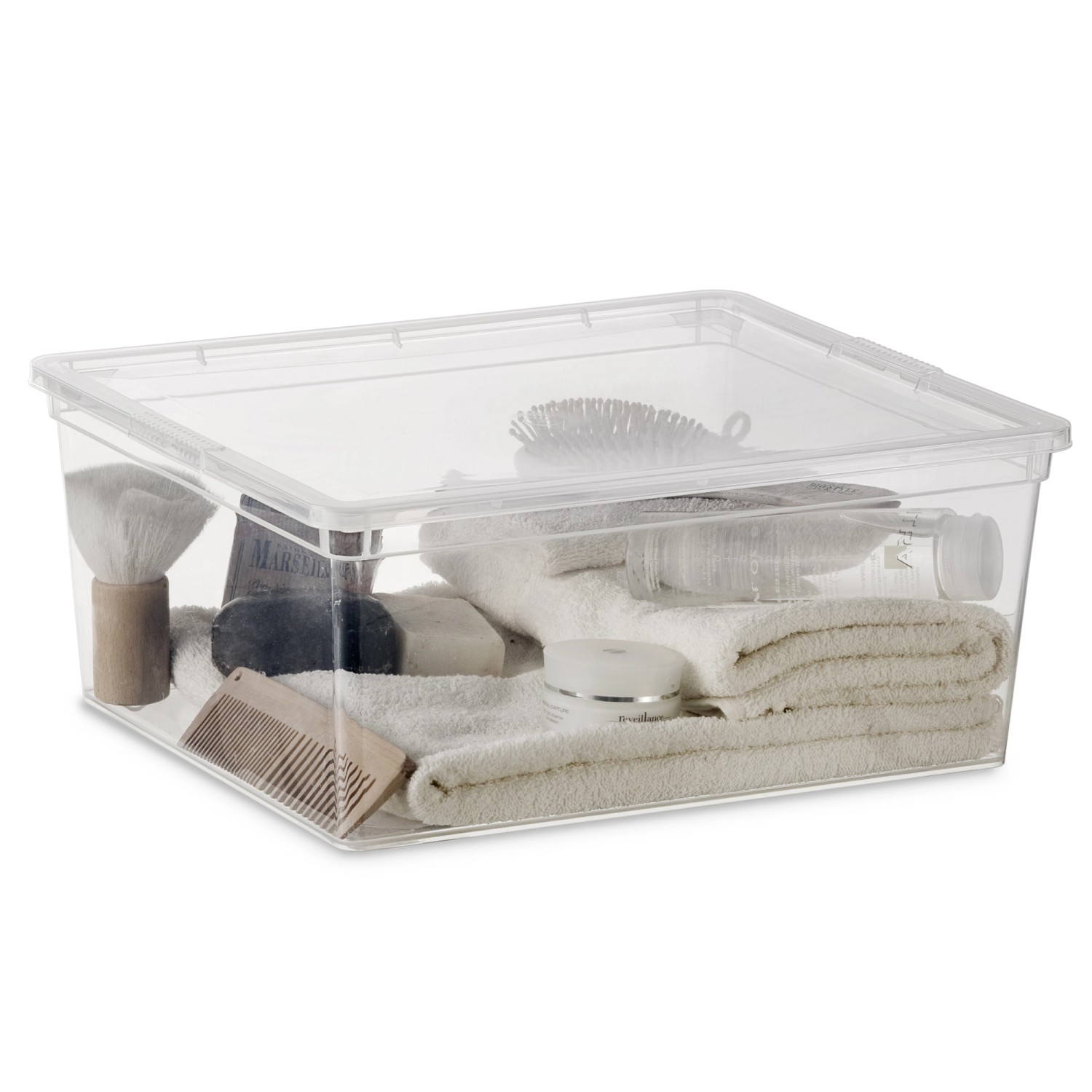 Scatola contenitore trasparente C M con coperchio, riempita con vari articoli da bagno.