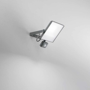 Faro da cantiere LED grigio con sensore di movimento montato a parete.