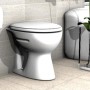 WC a pavimento bianco con porta carta igienica e decorazione in bagno.