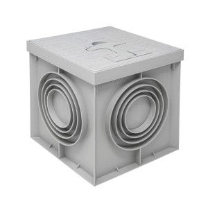 Pozzetto di scarico t.b.t. grigio con coperchio e attacchi laterali per tubi.