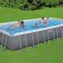 Piscina rettangolare con struttura in acciaio, piena d'acqua e con diverse persone. Categoria: Piscine fuori terra.