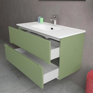 Mobile bagno verde con due cassetti e lavabo bianco.