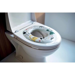 Riduttore WC con motivo dinosauri per bambini su un water.