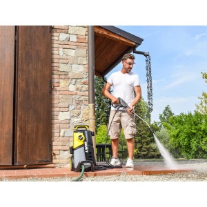 Idropulitrice giallo-grigia in uso, pulizia di pavimentazione in pietra.