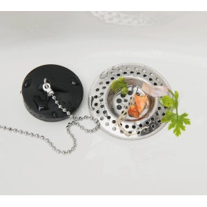 Set da 2 filtri di scarico Wenko in acciaio inox nel lavello con residui di cibo.