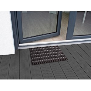 Zerbino nero OBI Quadro, 40x60 cm, davanti a una porta aperta su pavimento in legno scuro.