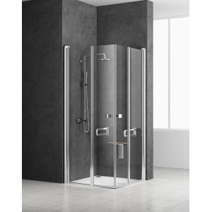 Box doccia angolare con telaio cromato e sistema doccia su parete scura.