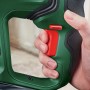 Dettaglio: mano che aziona il grilletto rosso sul trapano a percussione a batteria Bosch UniversalHammer 18V verde.