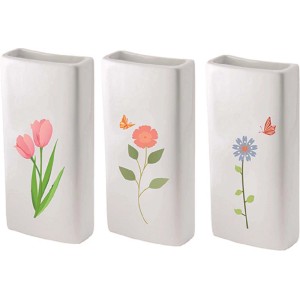 Tre t.b.t. bianchi con motivi floreali: tulipani, fiore con farfalla, margherita con farfalla.